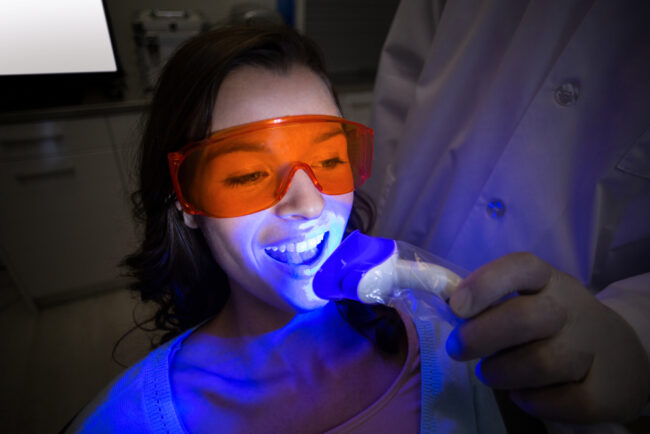 female dental patient undergoing laser dentistry for teeth whitening