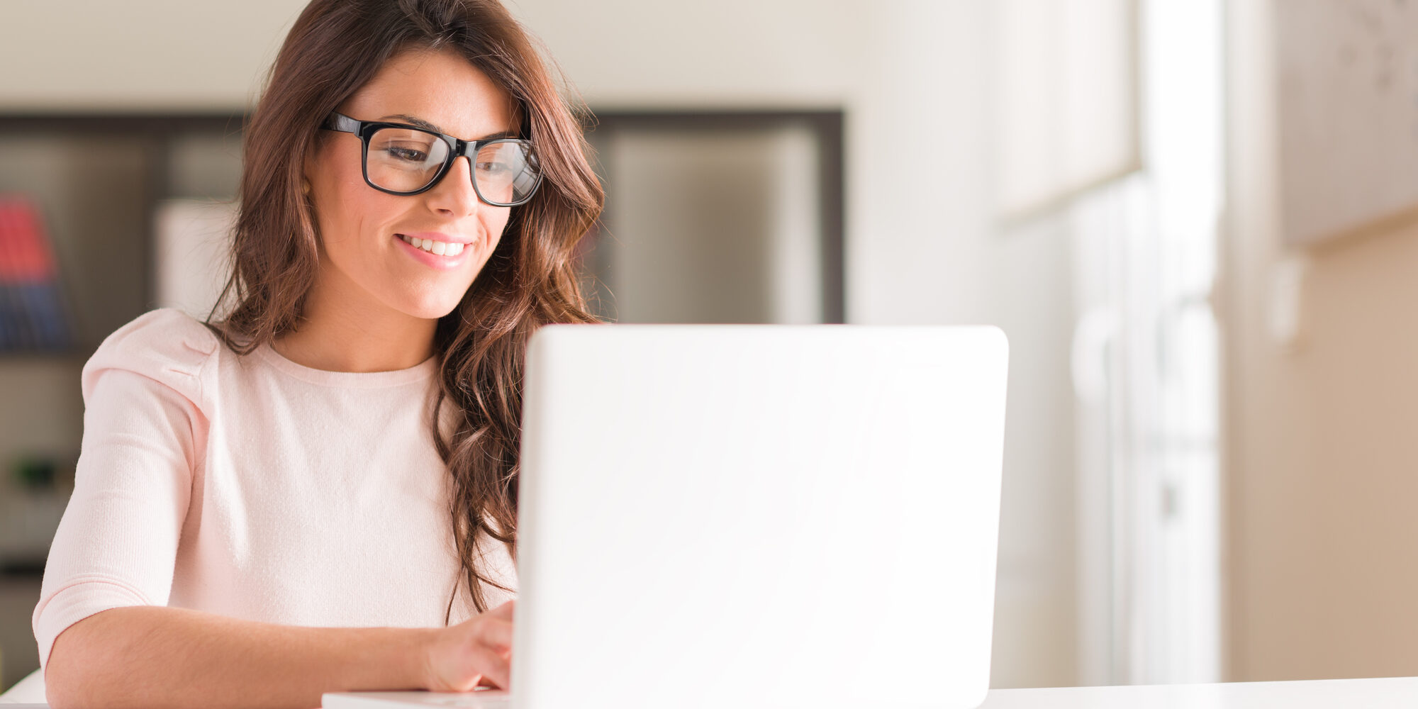Young Woman Using Laptop dental insurance research: the importance of finding an insurance dentist!
