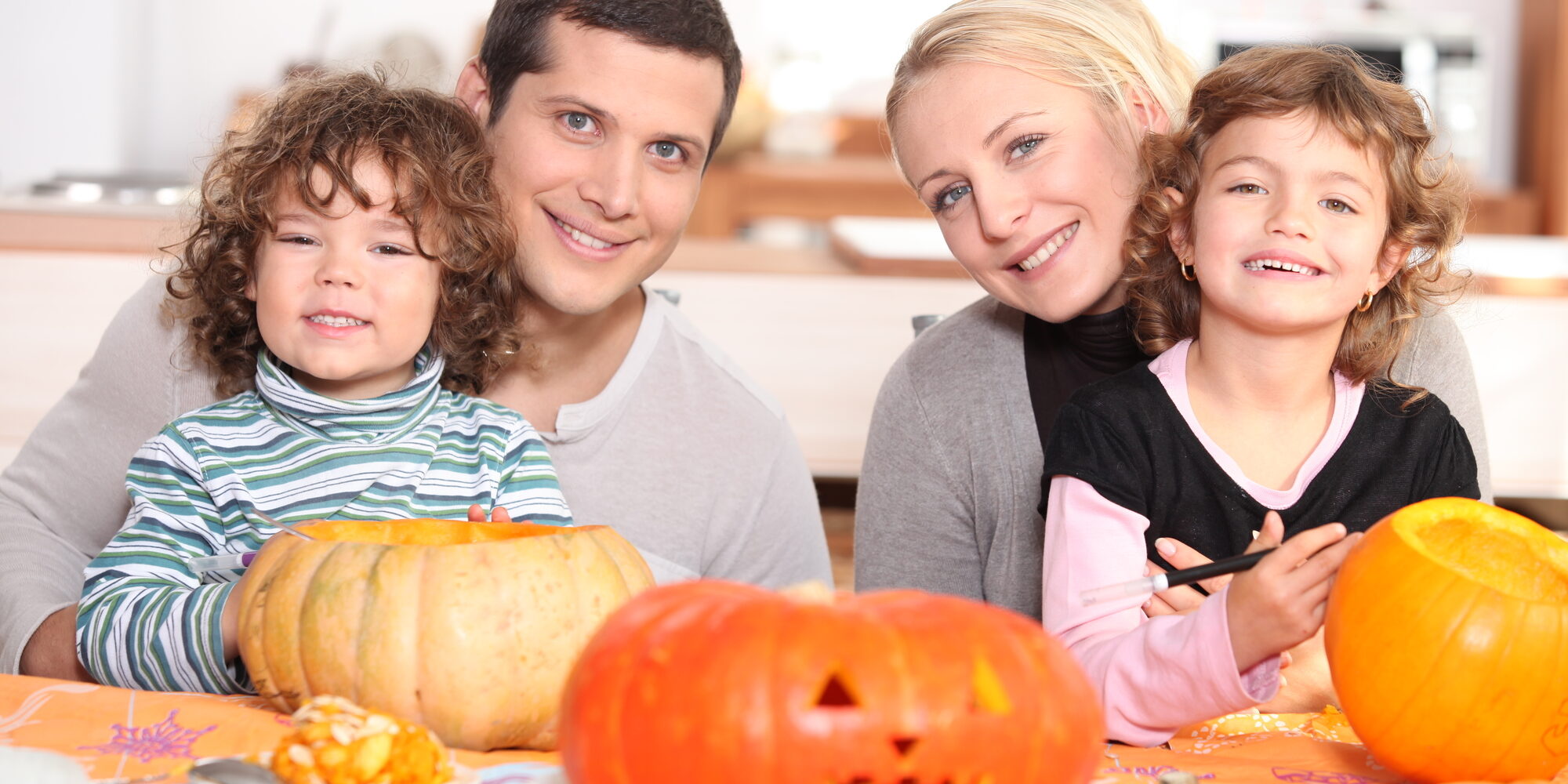 family carving pumpkins