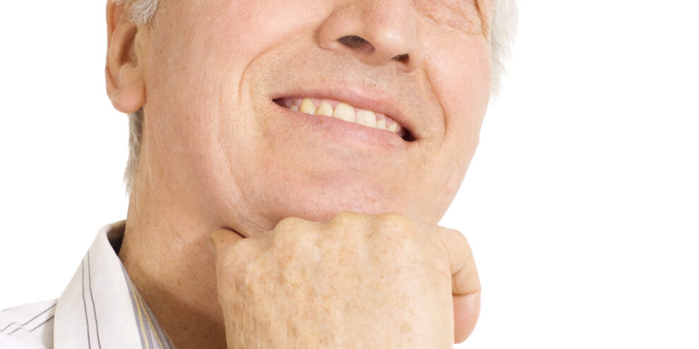 Older man contemplates questions to ask his Duncan dentist