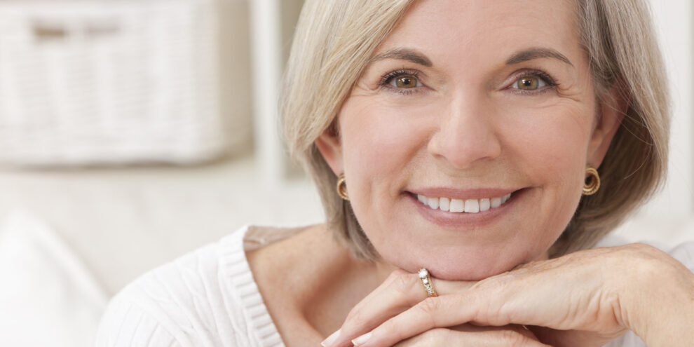 Older woman smiles after visiting a dentist at Chisholm Trail