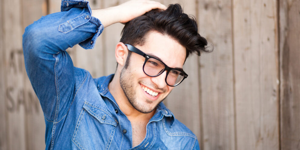 young man smiling outdoors after receiving cosmetic dentistry treatment in Duncan, OK