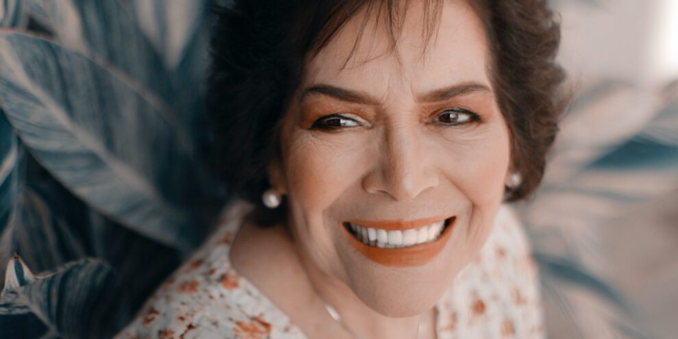 Smiling senior wondering, "What type of dentist does dentures?"