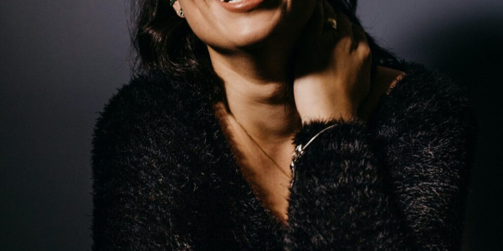 Woman smiling because of experienced implant dentist