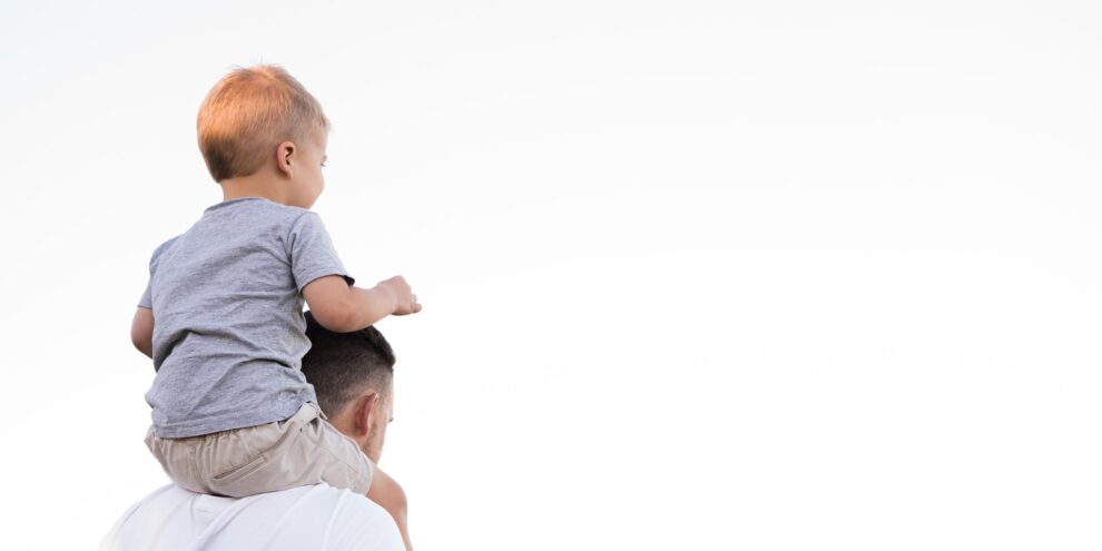 dad with young son on shoulders white background