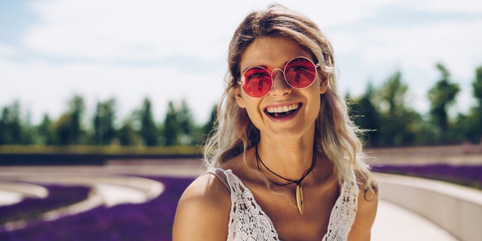 woman smiling in red sunglasses-dental crowns