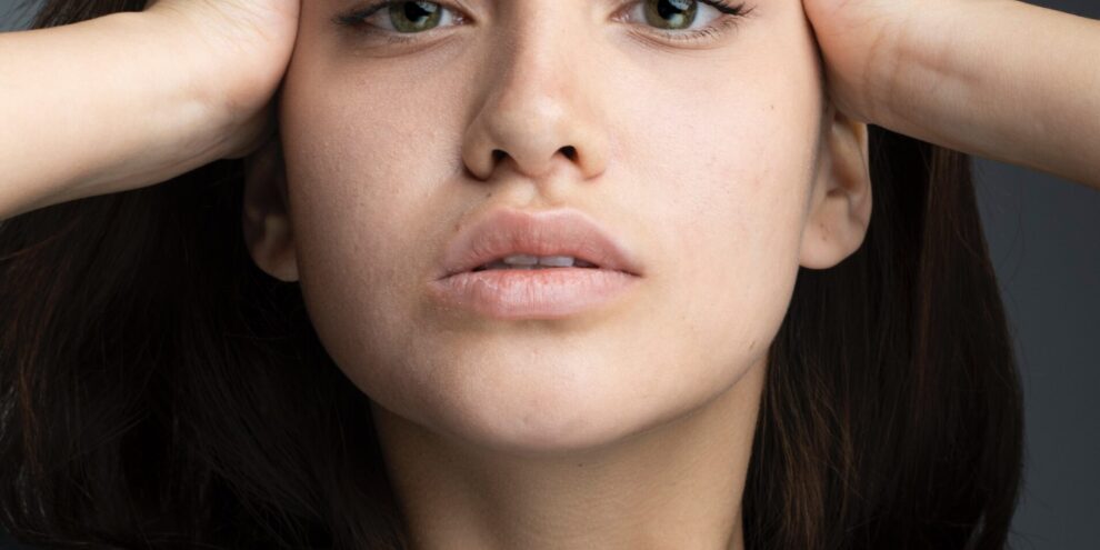 Woman with her hands on her head