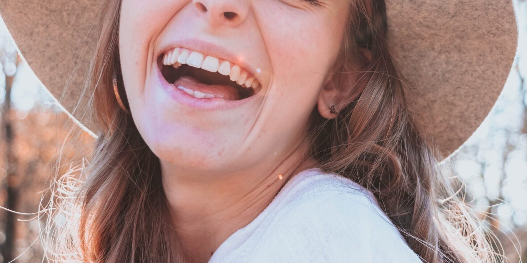 smiling young woman wearing a hat