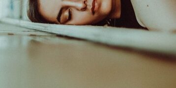 young woman asleep on table because of sleep apnea
