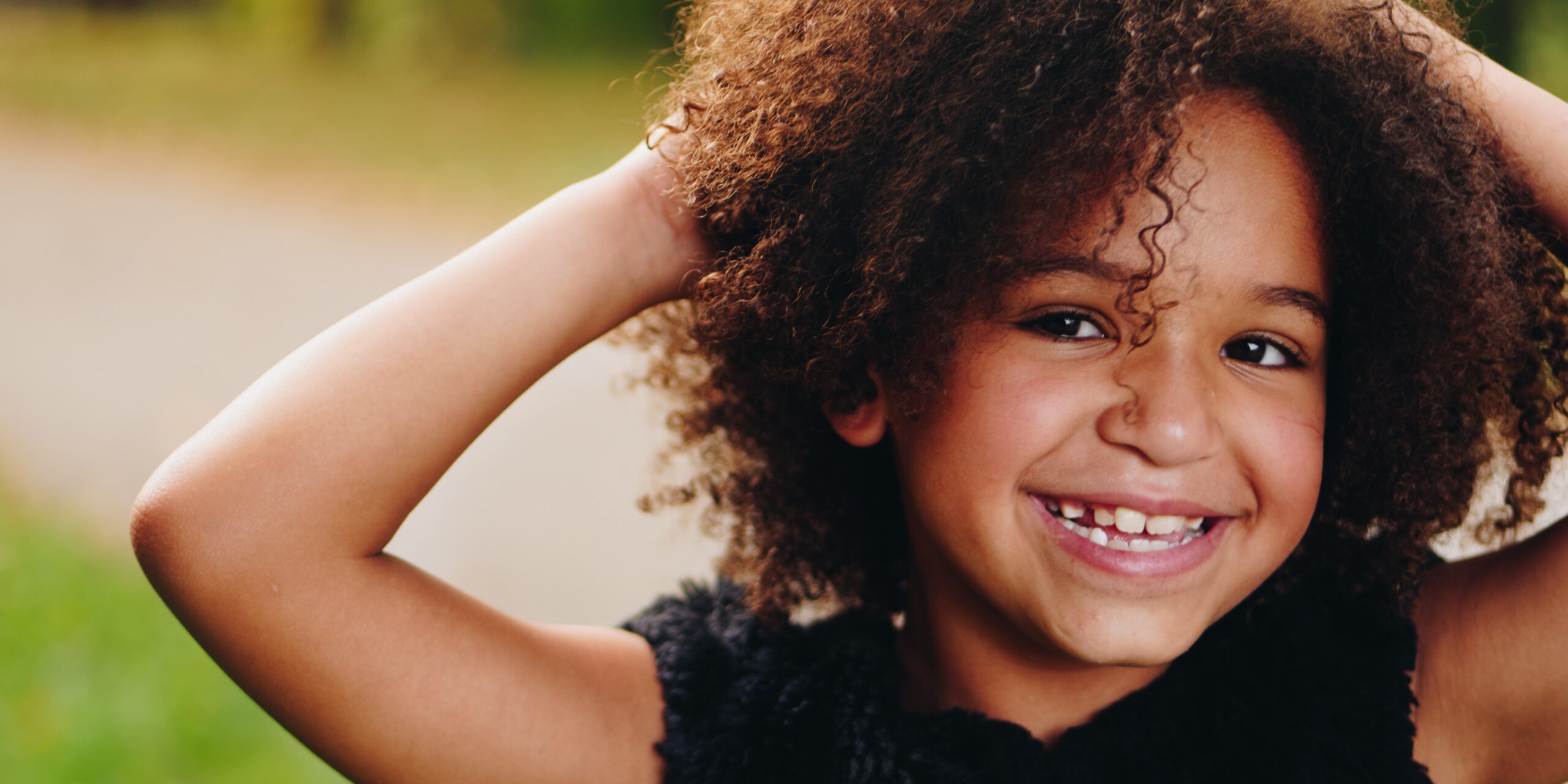 young african american girl with big smile, outdoors