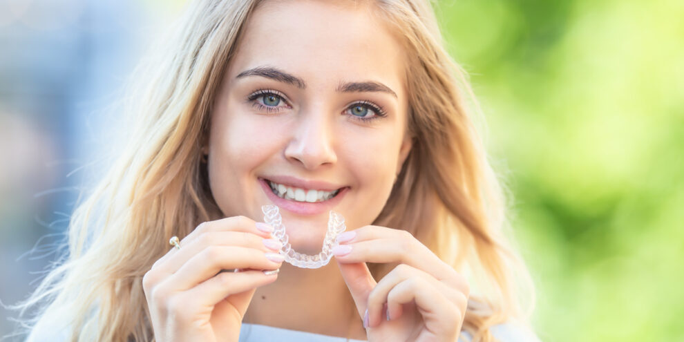 teen girl holding invisalign from her family dentist in duncan ok
