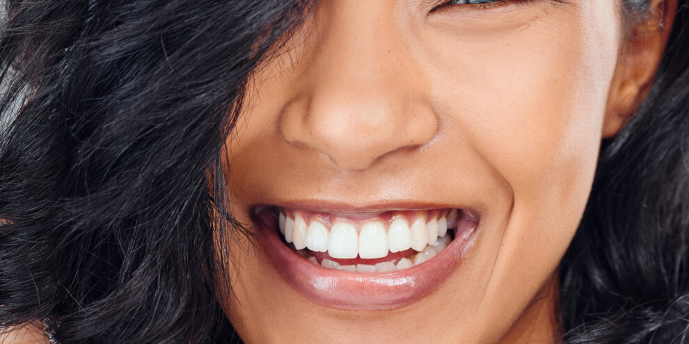close up picture of young woman with dark hair and beautiful smile