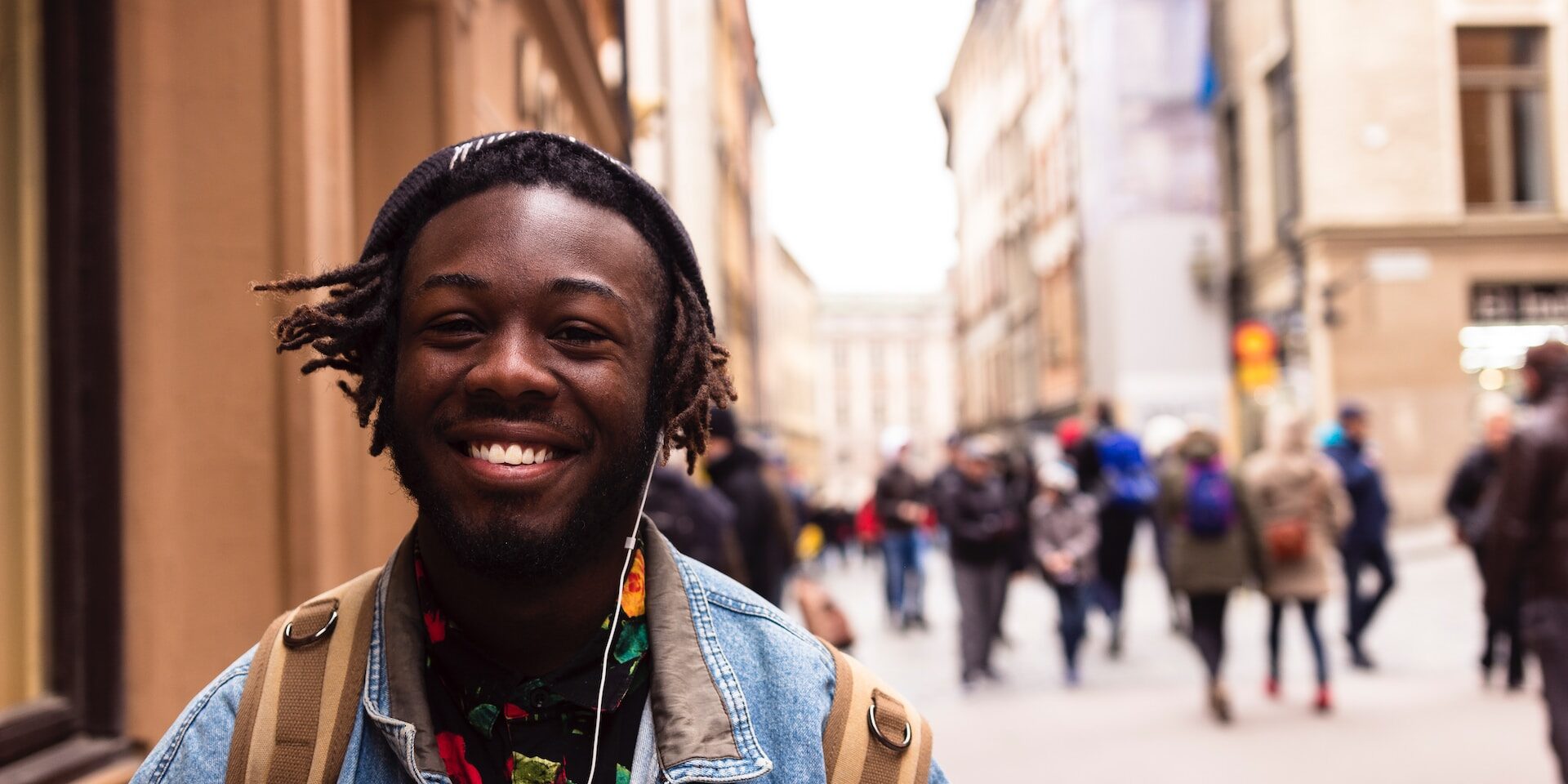 young black man smiling in the city