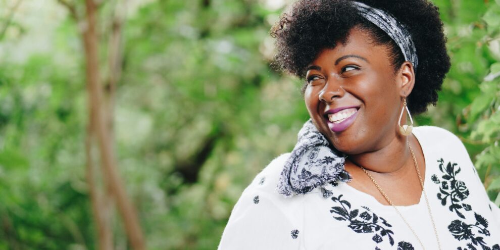 black woman looking back and smiling