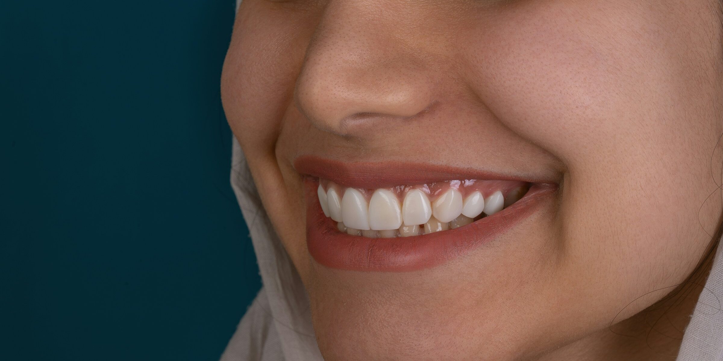 woman smiling on black background