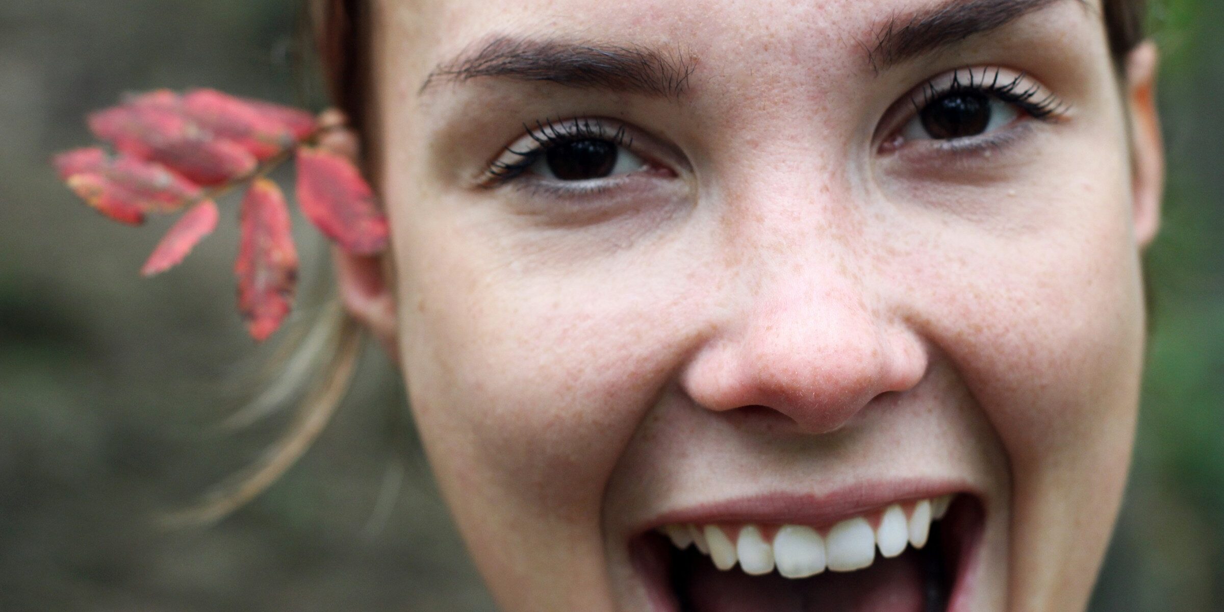 smiling woman with flower in her hair