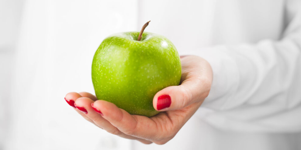 green apple in hand of Duncan OK denitst