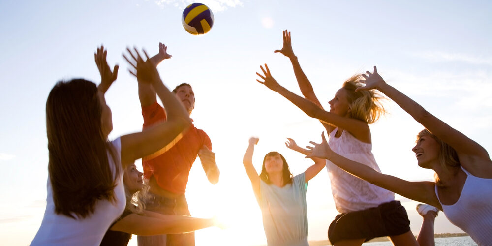 family playing beach volleyball