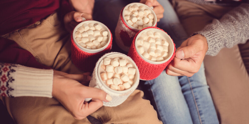 family holding mugs with hot cocoa