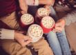 family holding mugs with hot cocoa