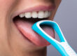 woman using a tongue scraper for bad breath