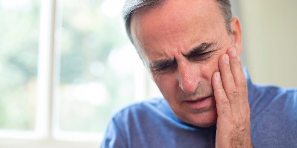 man suffering from dental emergency
