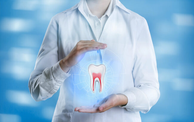 Dentist showing virtual model of tooth on light blue background