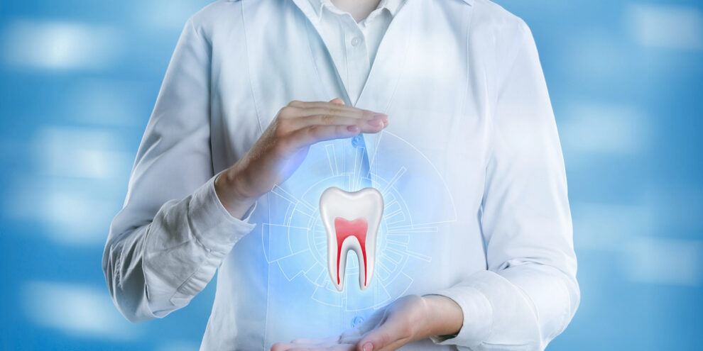 Dentist showing virtual model of tooth on light blue background